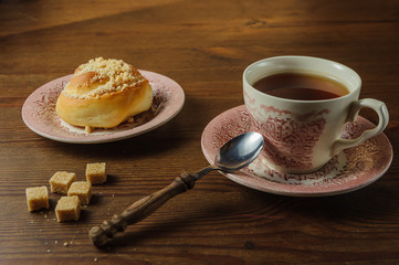 tea with a bun on an old kitchen table1