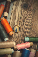 Vintage spools with multi colored threads and old button