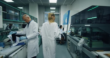 Slow motion shot of scientists work in research lab - Powered by Adobe