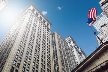 Building in Wall Street financial district with United States of America flag.