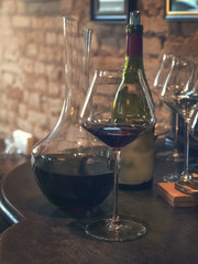 Vintage wine poured into glasses and decanter.