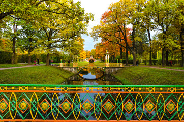 Patterned bridges and gazebo in Chinese style against the background of trees in Golden autumn...