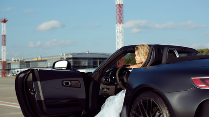 Fashion portrait of dreamy woman in the luxury car. No retouch.