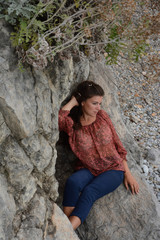 Happy woman relaxing and enjoying at the beach during travel holidays vacation outdoors at ocean or nature sea