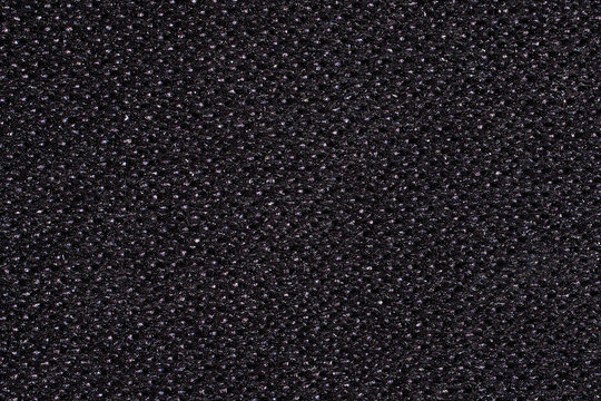 Abstract background. Black Kevlar fabric close-up. Macro photography