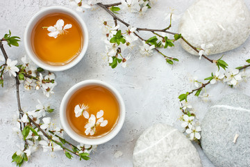 Oriental composition with tea cup and cherry  flowers