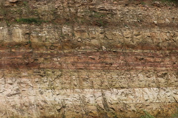 Beautiful sandstone wall showing layers of sediment deposits and drill marks in central Wisconsin