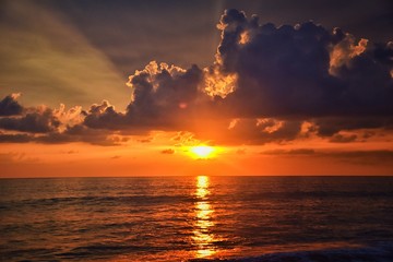 Obraz premium Phuket beach sunset, colorful cloudy twilight sky reflecting on the sand gazing at the Indian Ocean, Thailand, Asia.