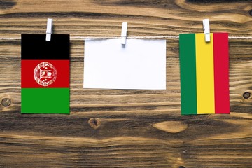 Hanging flags of Afghanistan and Bolivia attached to rope with clothes pins with copy space on...