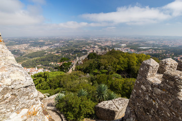 Fototapeta na wymiar Scenic view of medieval hilltop castle Castelo dos Mouros (The Castle of the Moors) and Sintra municipality and beyond from above in Portugal.