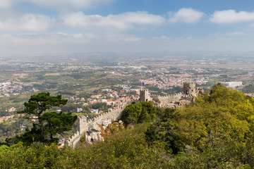 Scenic view of medieval hilltop castle Castelo dos Mouros (The Castle of the Moors) and Sintra municipality and beyond from above in Portugal.