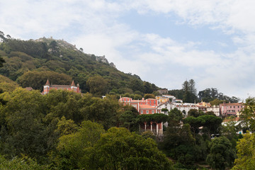 View of old buildings at Sintra's old town and the medieval hilltop castle Castelo dos Mouros (The Castle of the Moors) in Portugal.