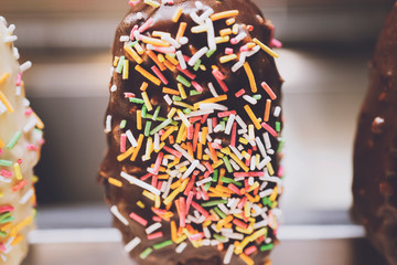 Obraz premium Ice cream with sprinkling on blur background