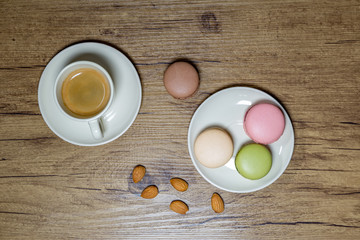 rustic photograph of macarons and coffee with almonds on wooden table