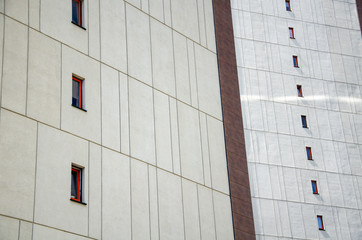 Obraz premium Architectural background, gray decorative wall with windows of a modern building, minimalism style