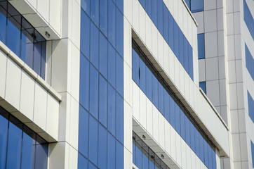 Fototapeta na wymiar Modern architectural background of metal panels and blue glazing