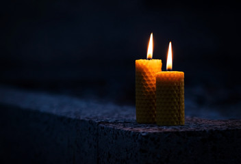 Two candles with beeswax on the monument - obrazy, fototapety, plakaty
