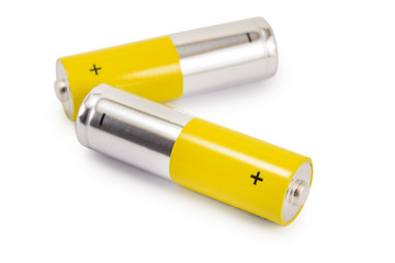 alkaline batteries and a yellow metal AA-size batteries isolated on white background closeup, carbon zinc batteries, rechargeable batteries, mockup