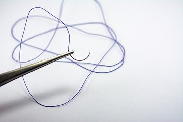 suture material close-up, thread for suturing wounds in medicine, dentistry, medical needle