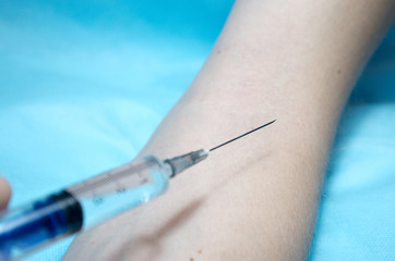 inoculation in the hand, vaccination, injection, syringe in the hands of a doctor