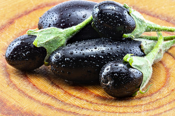 ripe eggplant on the wooden background, mini eggplant
