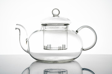 glass teapot on white background with reflection