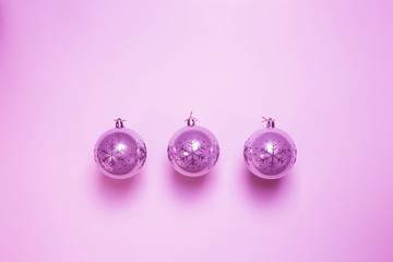 Pink Christmas ball baubles isolated on pink background, modern retro christmas ornament