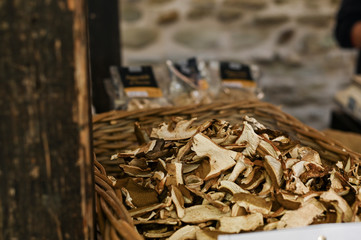 Homemade Dried Porcinis on a wooden table as a detailed close-up shot; Basket with mushrooms on the market.