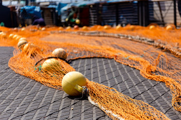 Yellow net with floats on the shore