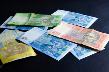 The Ukrainian hryvnia denominated five, ten, twenty hryvnias scattered and neatly linked. Hryvnia in male hands and in a wallet. Theft of Ukrainian hryvnia money