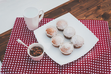 sweet muffins on a plate with a cup of chocolate