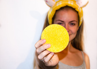A European girl is applying Korean cosmetics to her face mask. Cleanses pores, grease, acne,...
