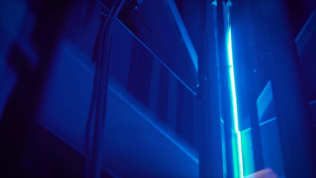 The elevator goes through the mine. elevator shaft with blue backlight. Highlighted elevator.