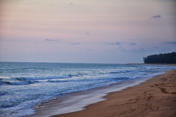 Fototapeta premium Phuket beach sunset, colorful cloudy twilight sky reflecting on the sand gazing at the Indian Ocean, Thailand, Asia.