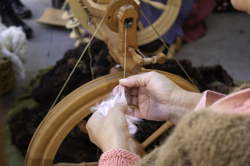 Spinning wool on spinning wheel