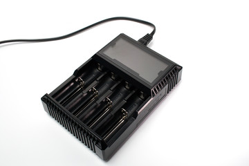 A black smart battery charger with a white background.