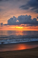 Fototapeta na wymiar Phuket beach sunset, colorful cloudy twilight sky reflecting on the sand gazing at the Indian Ocean, Thailand, Asia.