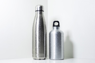 Steel and aluminium, eco thermo bottles for water, on white background.