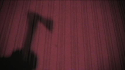 Vintage effect. A man kills his victim with an ax. old, glitch, retro, Murder. Shadow of the criminal on the wall. Halloween. The room is flooded with red light. Scene from a horror movie. Killer.