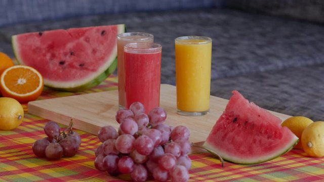 4K Static view of fruit and juices platter. Colorful shot for restaurants or hotel providing healthy meals. focus on glasses