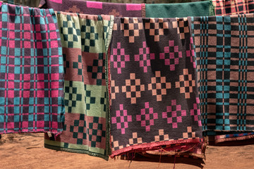 Colorful blankets hanging on a line to dry.  Image taken in Nairobi, Kenya.