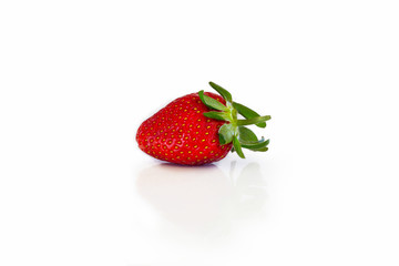 Fresh red strawberry with green leaves on a white background with bright yellow spots