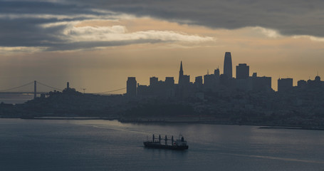Naklejka premium Tanker ship coming into the San Francisco, Ca. bay in the very early morning under a cloudy sky