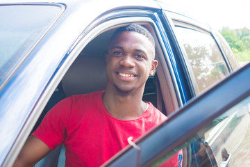 A young Nigerian taxi driver Waiting for passengers 