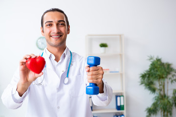 Young male doctor in sport and dieting concept