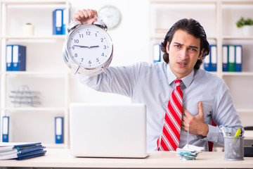 Young male employee suffering in the office