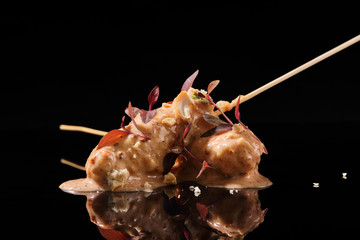Food in batter on a black background with flowers