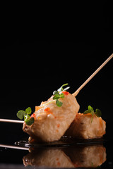 Food in batter on a black background with flowers