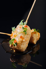 Food in batter on a black background with flowers