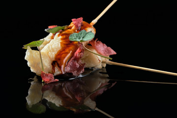 Food in batter on a black background with flowers